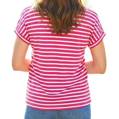 Person wearing a pink and white striped shirt with a blurred natural background