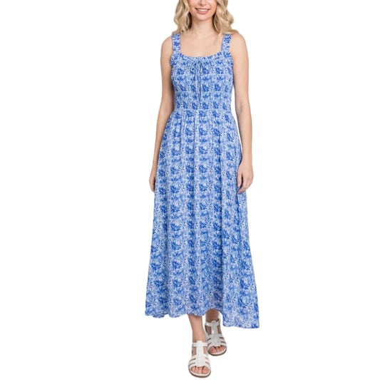 Woman wearing a blue floral dress on a white background