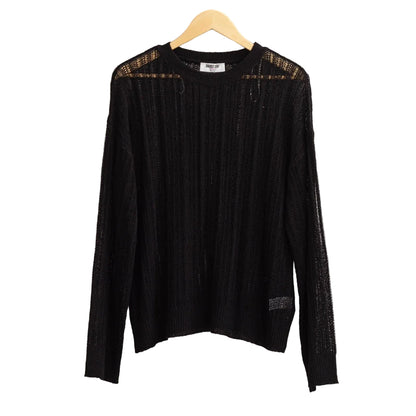 Black long-sleeve top on a hanger against a light gray background