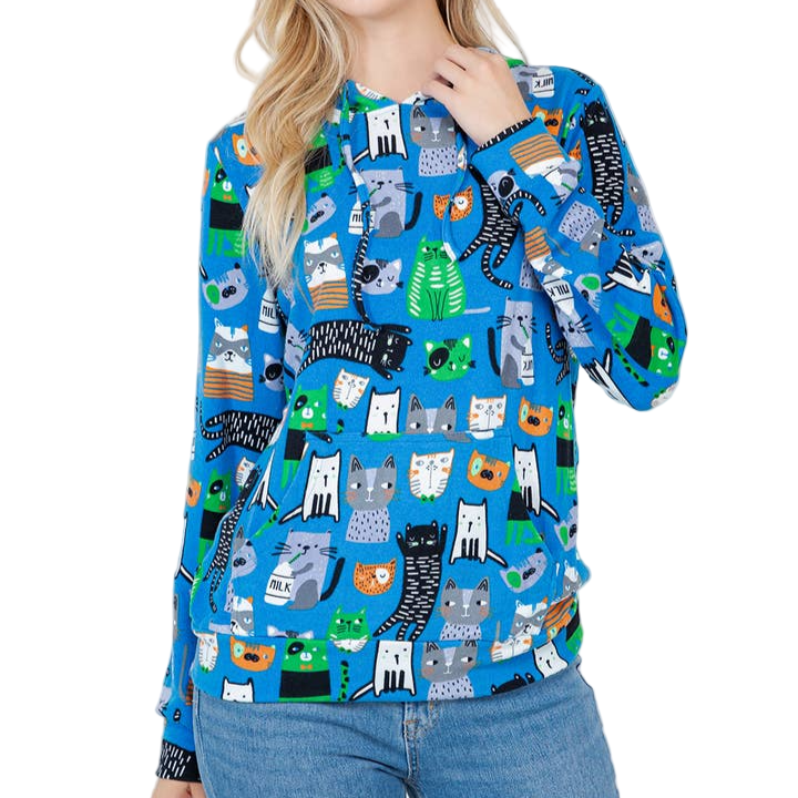 Woman wearing a blue sweatshirt with cat pattern on a white background