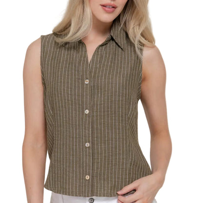 Woman wearing a sleeveless brown striped shirt with white pants on a plain background