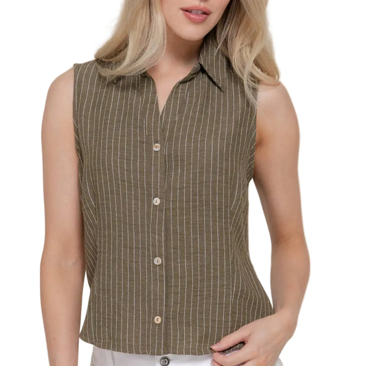 Woman wearing a sleeveless brown striped shirt with white pants on a plain background
