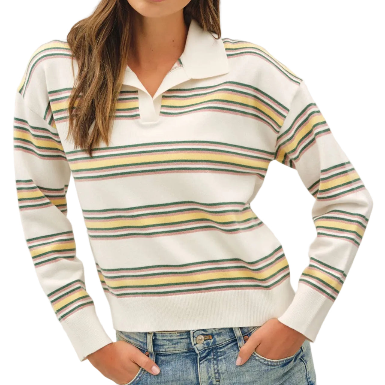 A woman wearing a white long-sleeve knit polo sweater with horizontal stripes in yellow, navy, and gray, paired with light-wash blue jeans, against a light gray studio background.