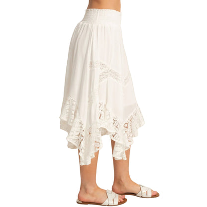White lace skirt worn by a person on a plain background