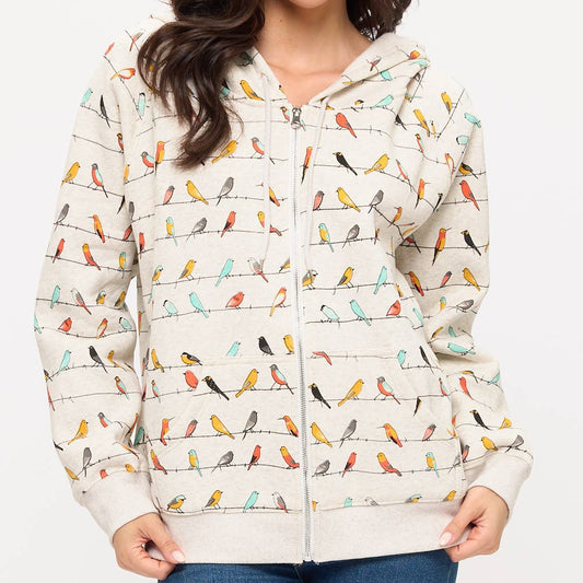 Woman wearing a jacket with bird pattern on a white background