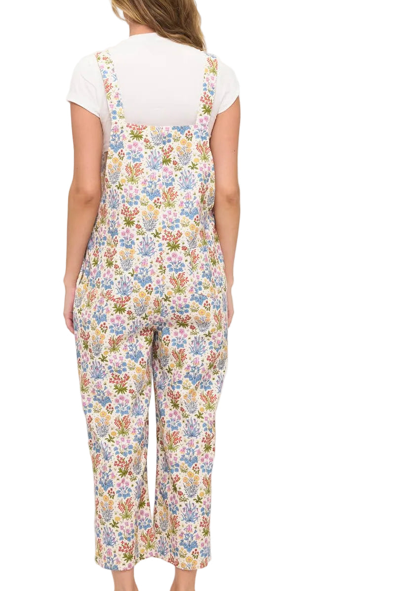 Woman wearing a floral overalls on a white background