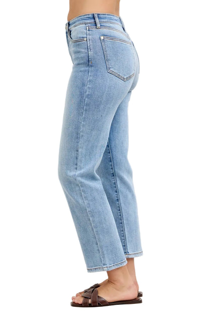 Light blue jeans worn by a person on a plain background