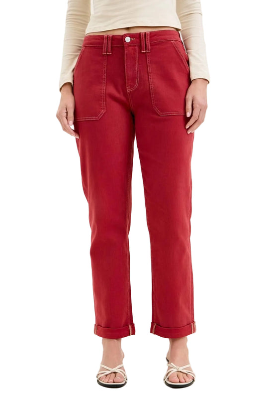 Red pants worn by a person on a white background
