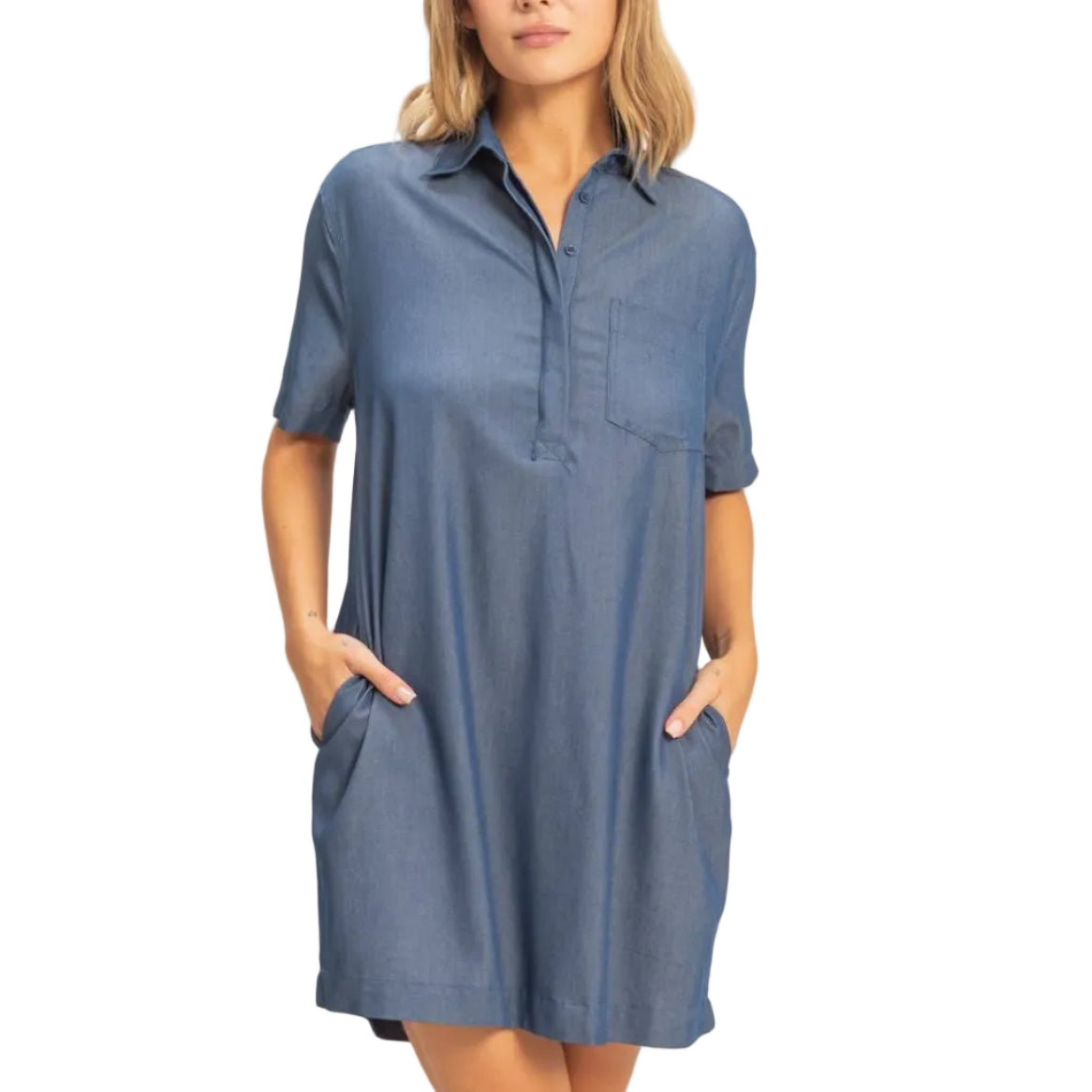 Woman wearing a blue dress with short sleeves and pockets on a white background