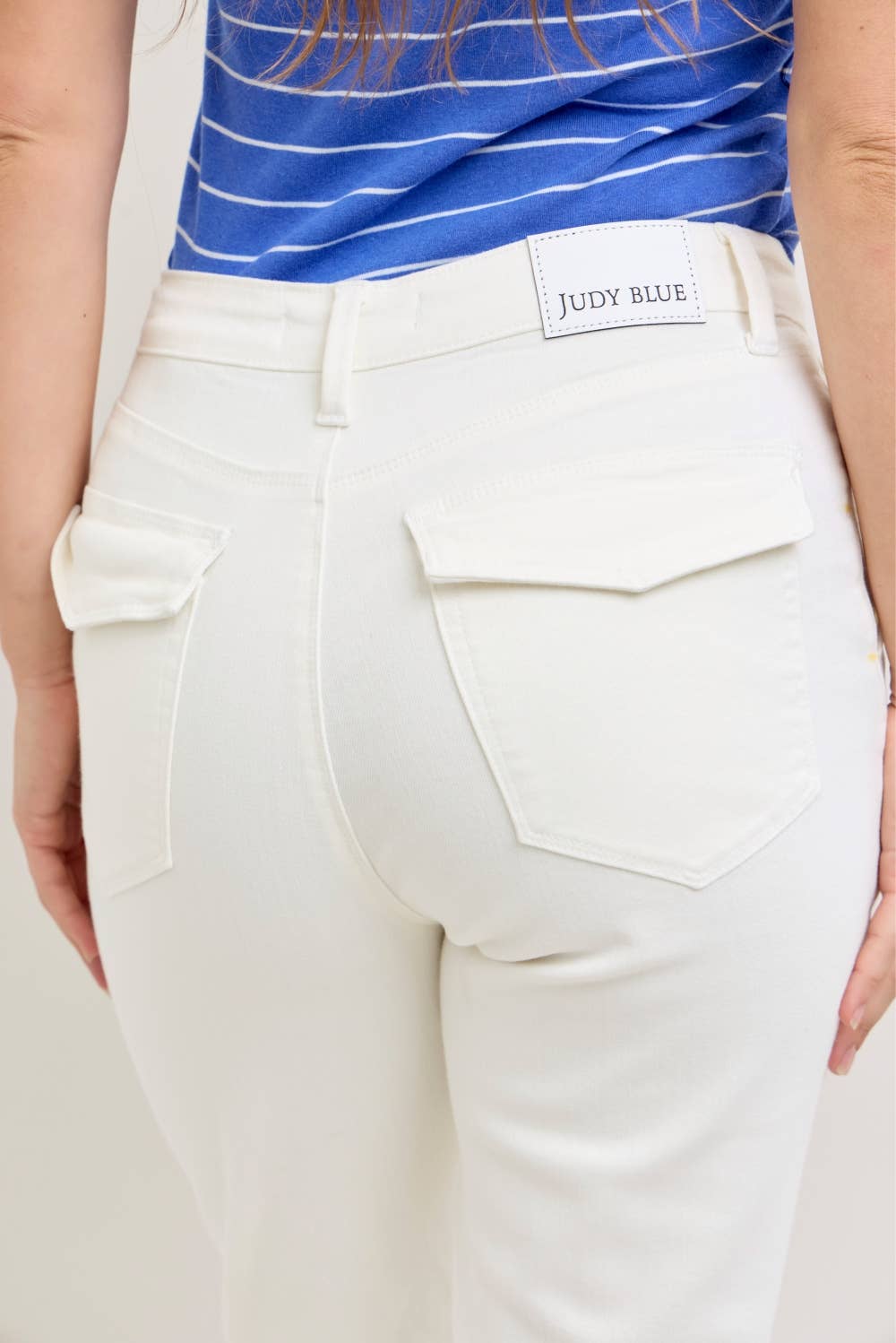 White pants with a visible brand label on a neutral background