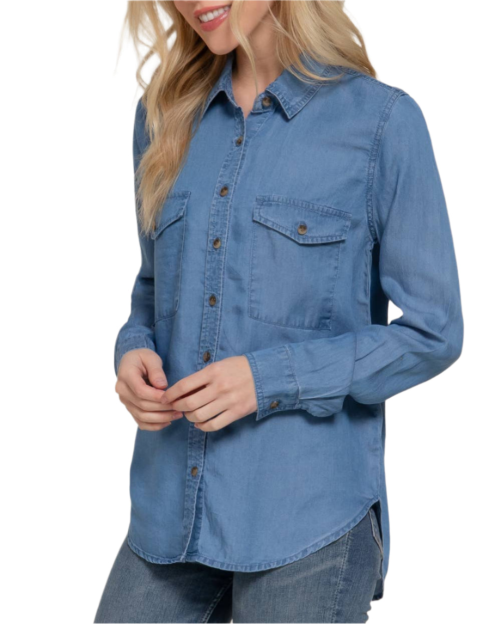 Woman wearing a blue denim shirt against a plain background