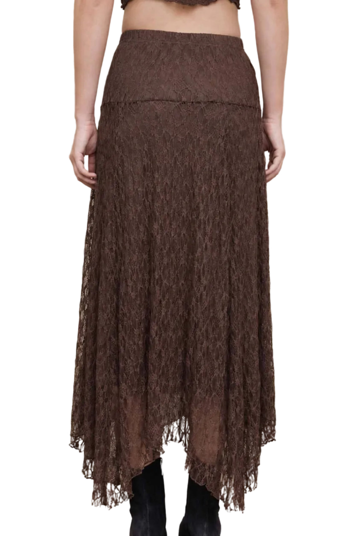 A woman shown from the back wearing a brown lace midi skirt with a high-waisted design and black ankle boots, standing against a beige concrete wall.