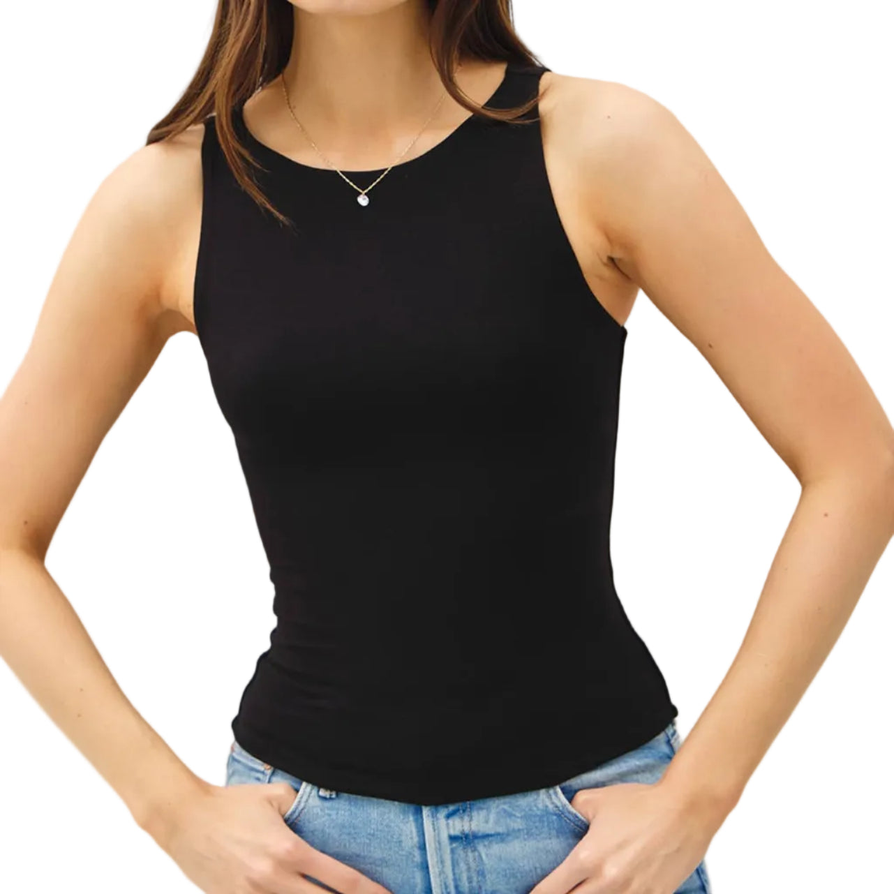 Woman wearing a black tank top and blue jeans against a plain background