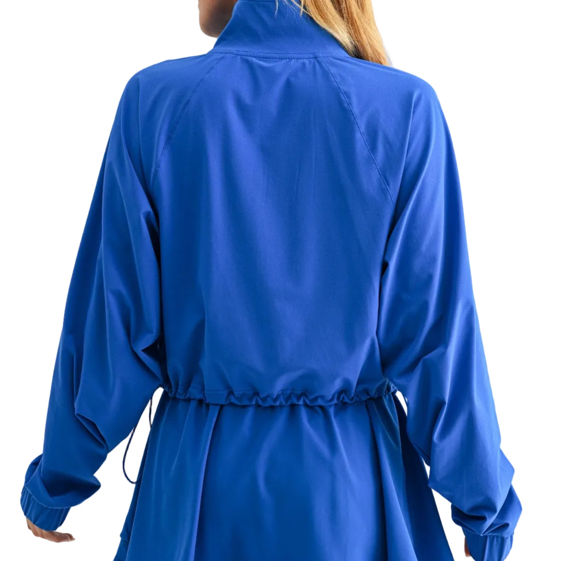Person wearing a blue jacket and skirt set on a white background