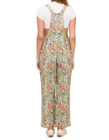 Woman wearing a floral overalls on a white background