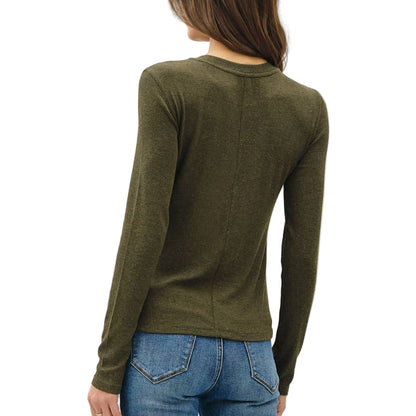 Person wearing a green sweater and blue jeans on a white background