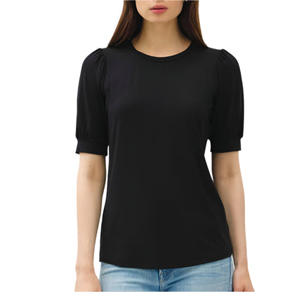 Woman wearing a black top and light blue jeans on a white background