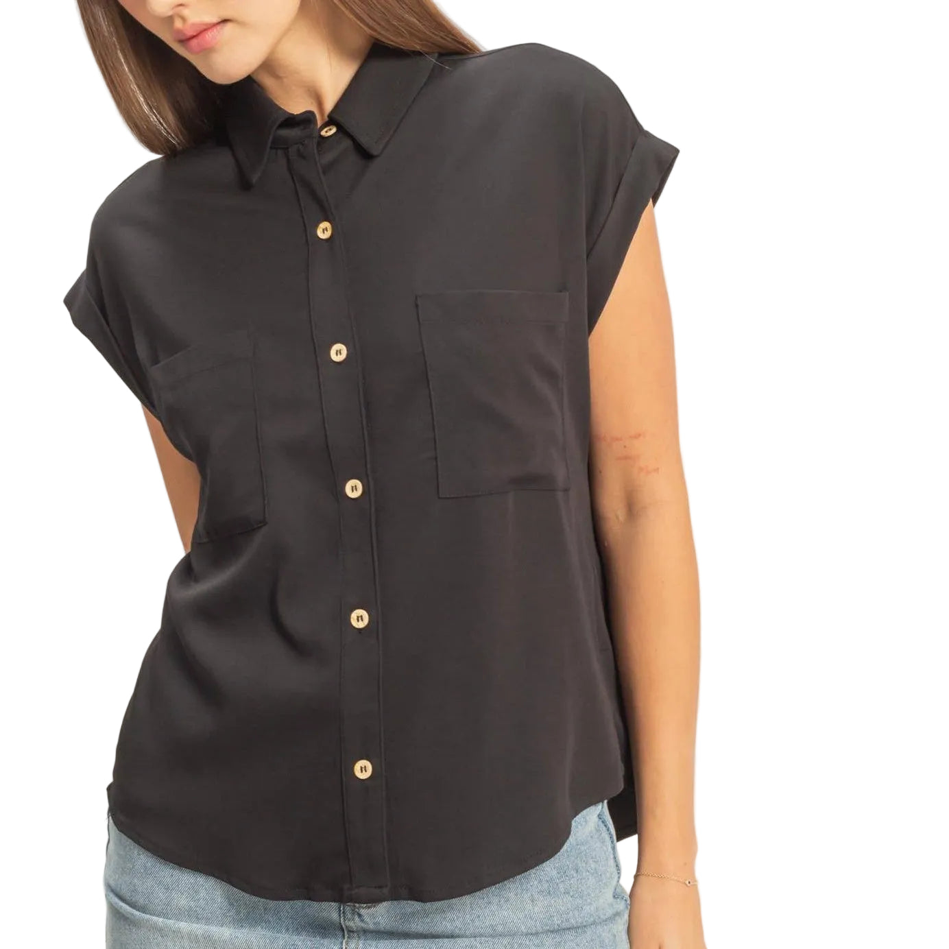 Woman wearing a black sleeveless shirt with gold buttons and a denim skirt on a white background