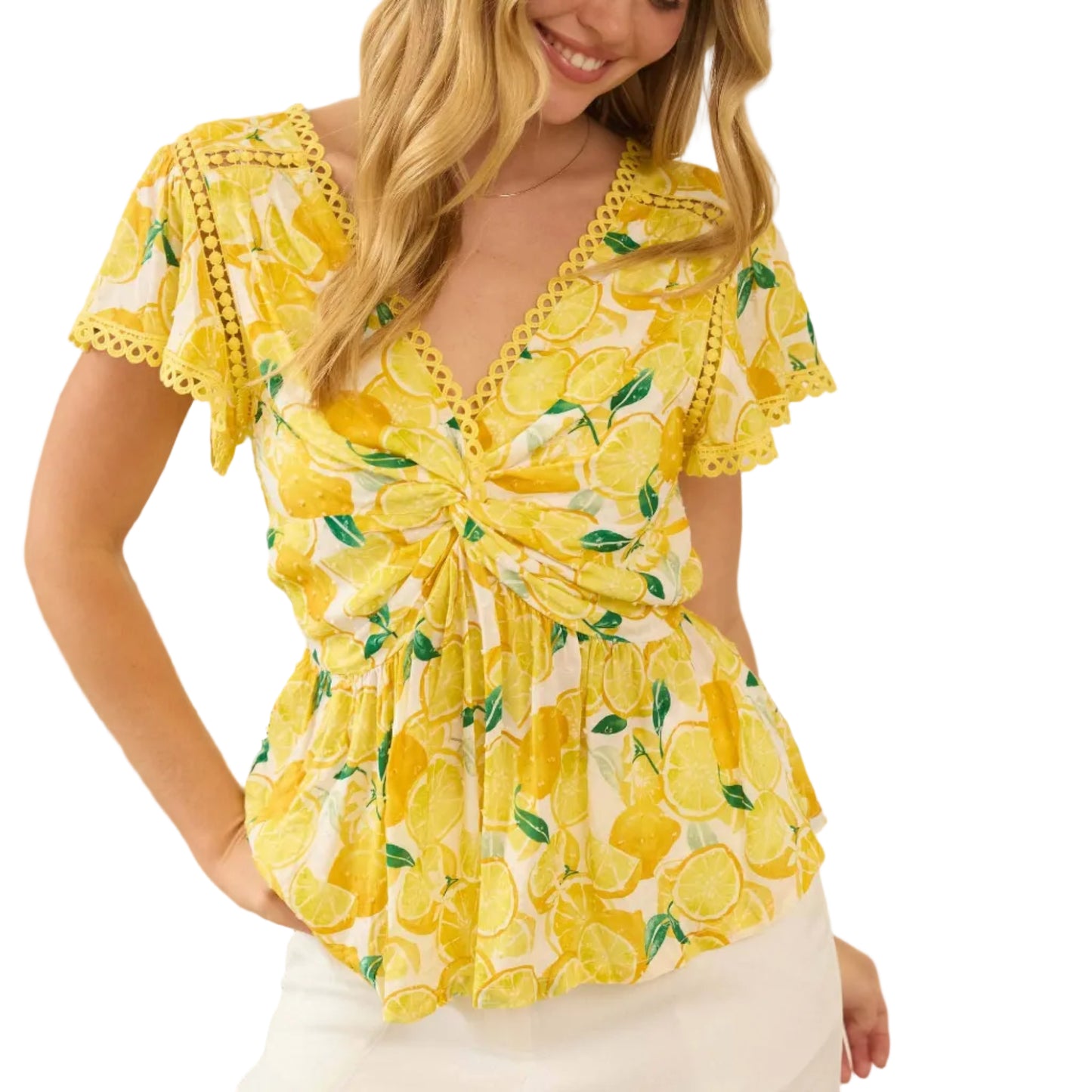 Woman wearing a yellow floral top with a blurred indoor background
