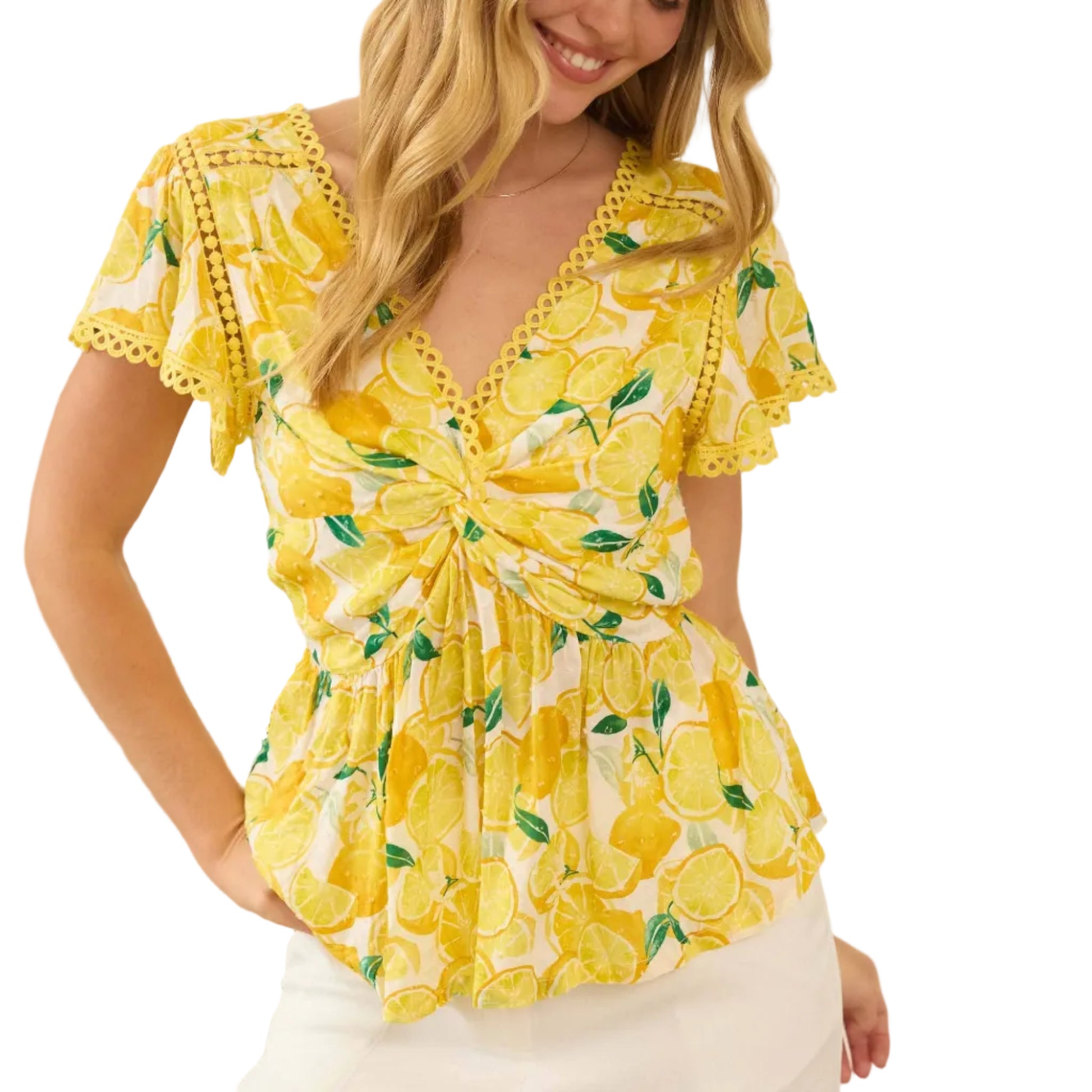 Woman wearing a yellow floral top with a blurred indoor background