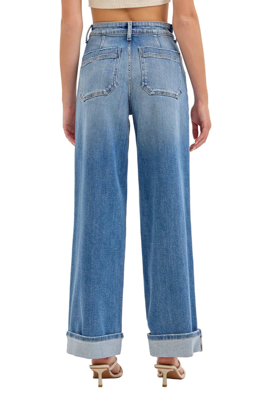 Blue jeans worn by a person on a light gray background
