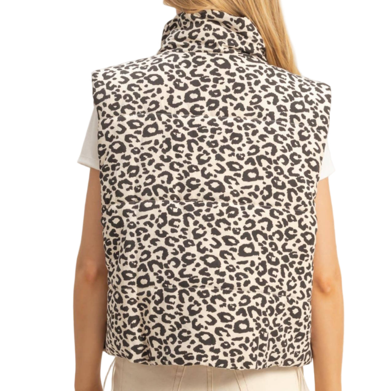 Person wearing a leopard print vest against a plain background