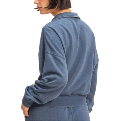 Person wearing a blue tracksuit on a white background