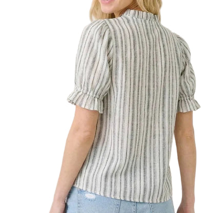Woman wearing a striped blouse with puff sleeves on a beige background
