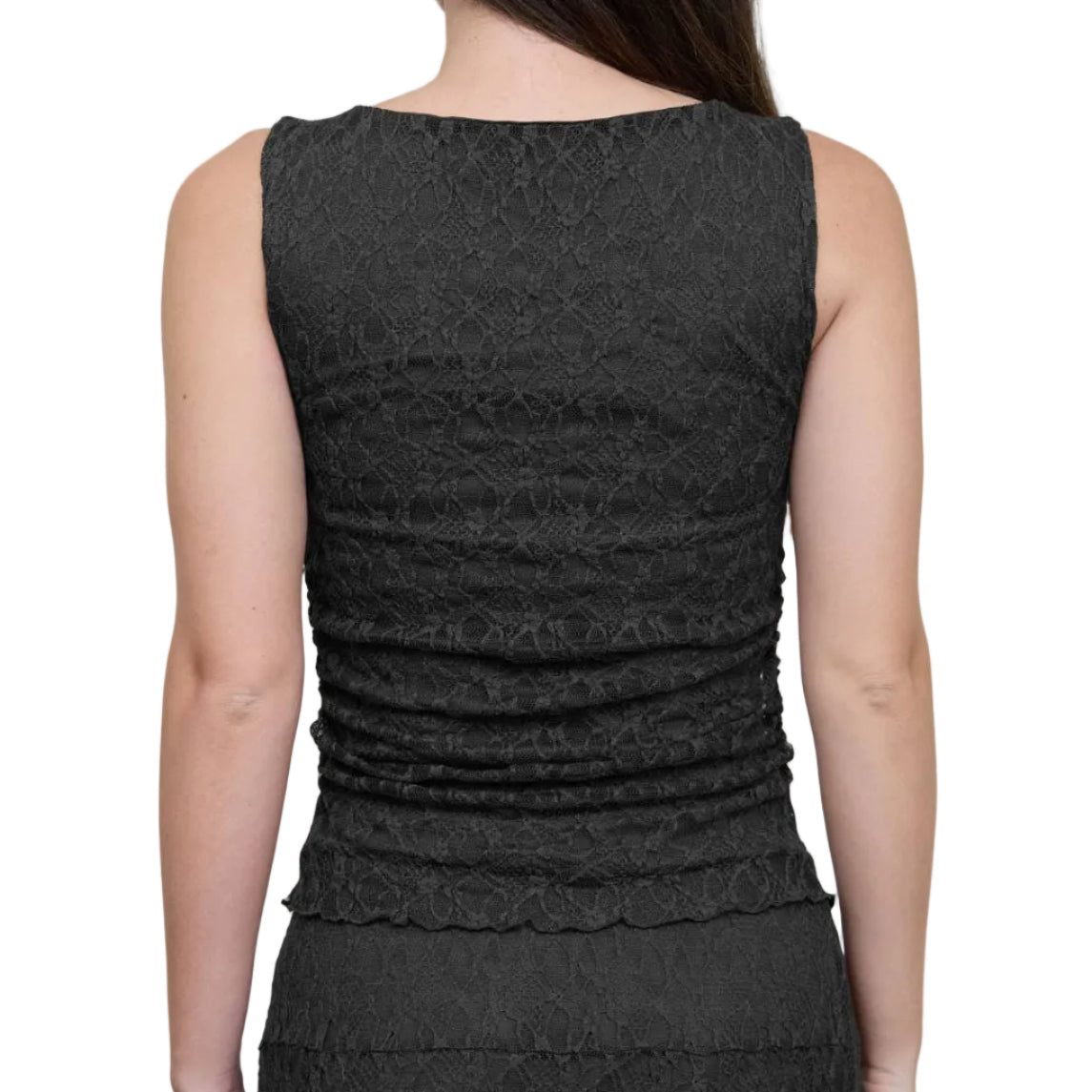A woman shown from the back wearing a sleeveless black textured dress with ruching and a fringed hem, photographed against a light gray studio background.