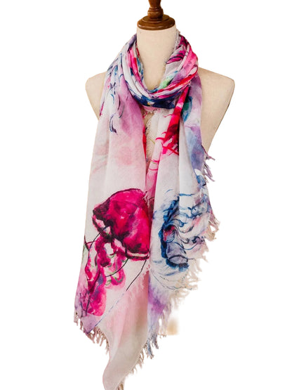 Mannequin wearing a colorful scarf with floral design in a store setting.