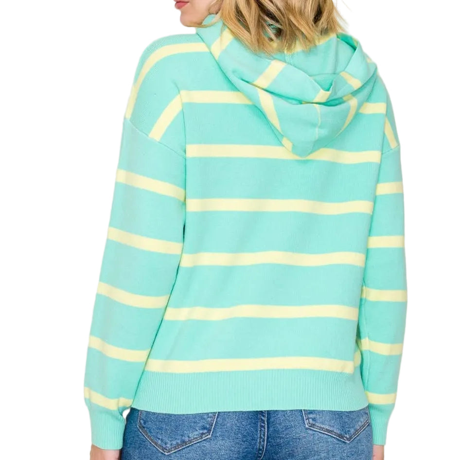 Woman wearing a light blue and yellow striped hoodie against a plain background