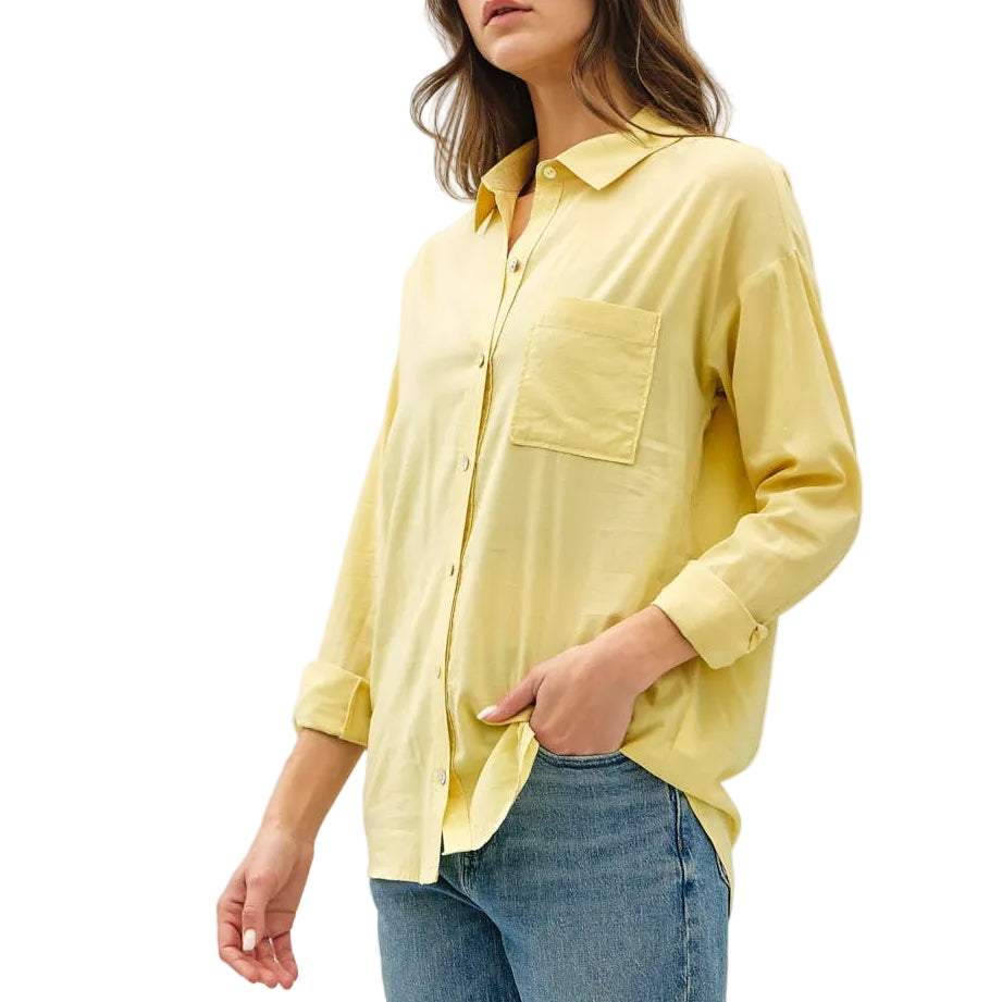 Woman wearing a yellow shirt and blue jeans on a white background