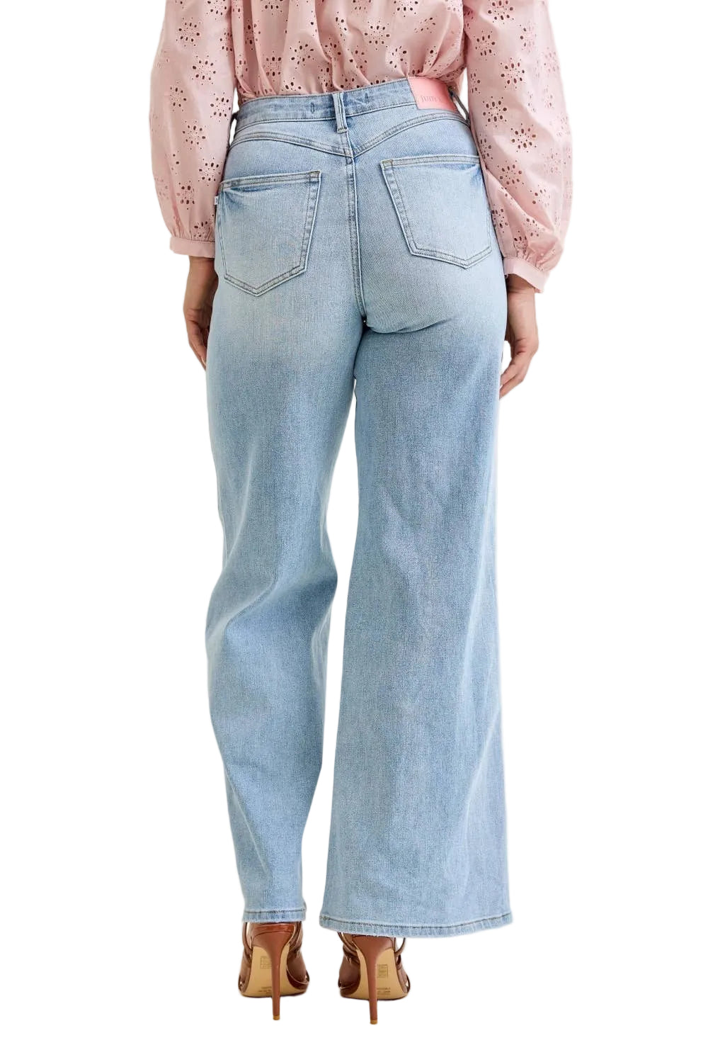 Light blue jeans worn by a person on a plain background