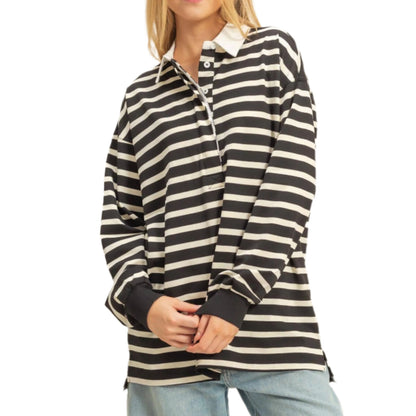 Person wearing a black and white striped shirt with light blue jeans on a beige background