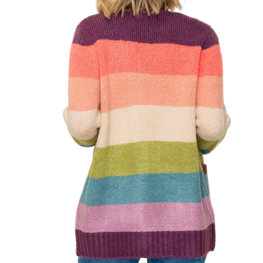 Person wearing a colorful striped sweater against a plain background