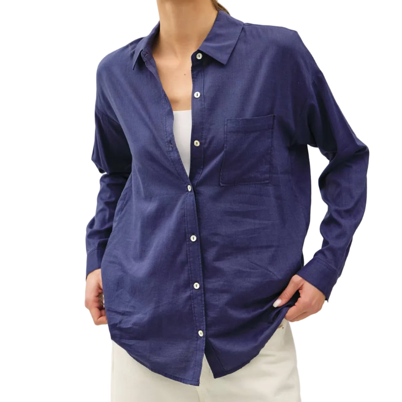 Woman wearing a blue button-up shirt over a white top on a plain background