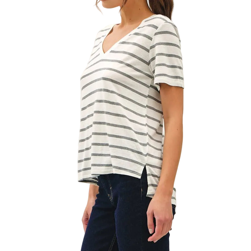 Woman wearing a striped shirt and dark pants on a white background