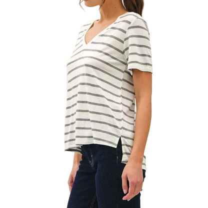 Woman wearing a striped shirt and dark pants on a white background