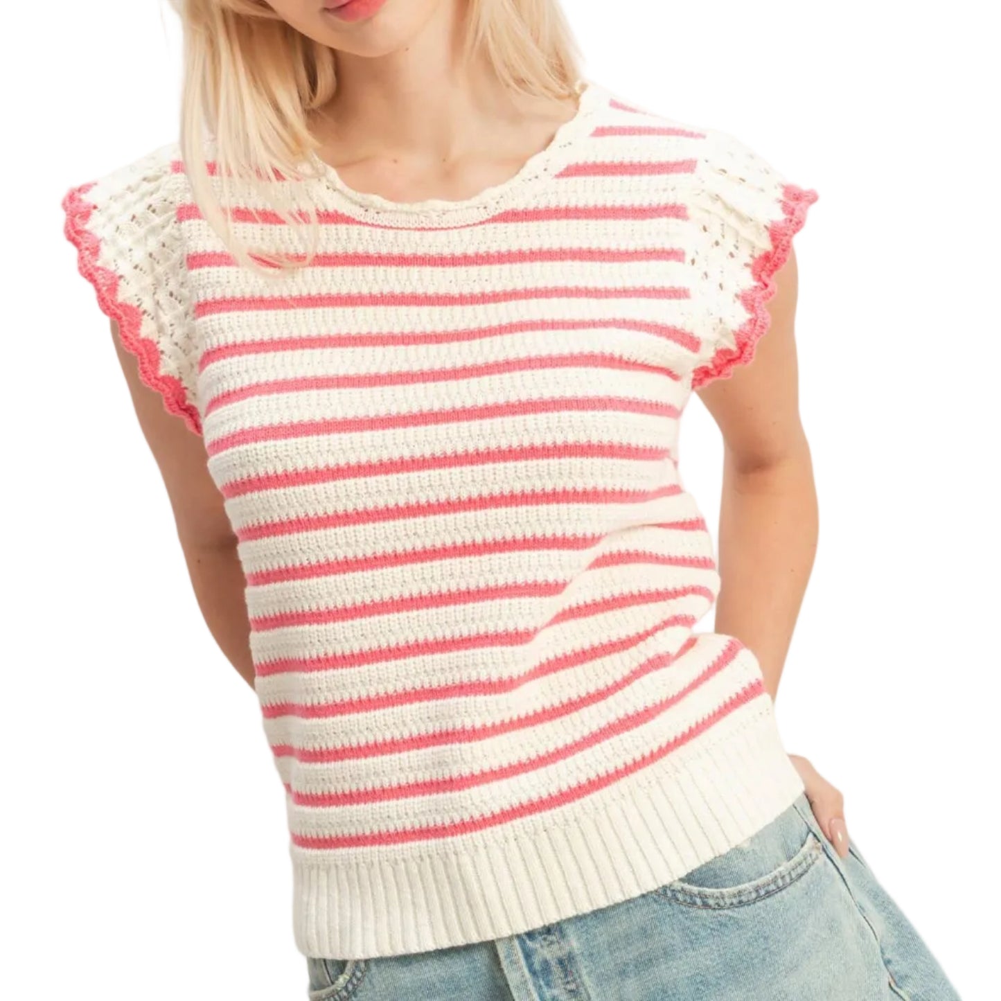 Woman wearing a pink and white striped sweater with lace sleeves on a plain background