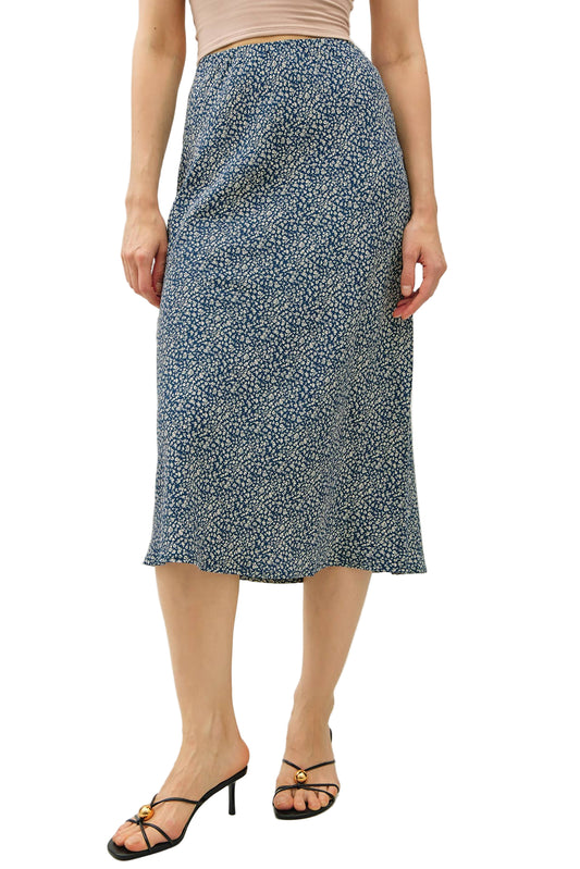 Person wearing a blue floral skirt on a white background