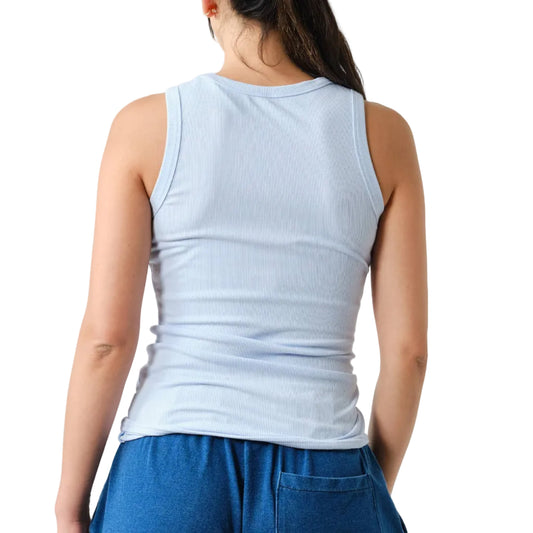 Person wearing a light blue sleeveless top and blue pants on a white background