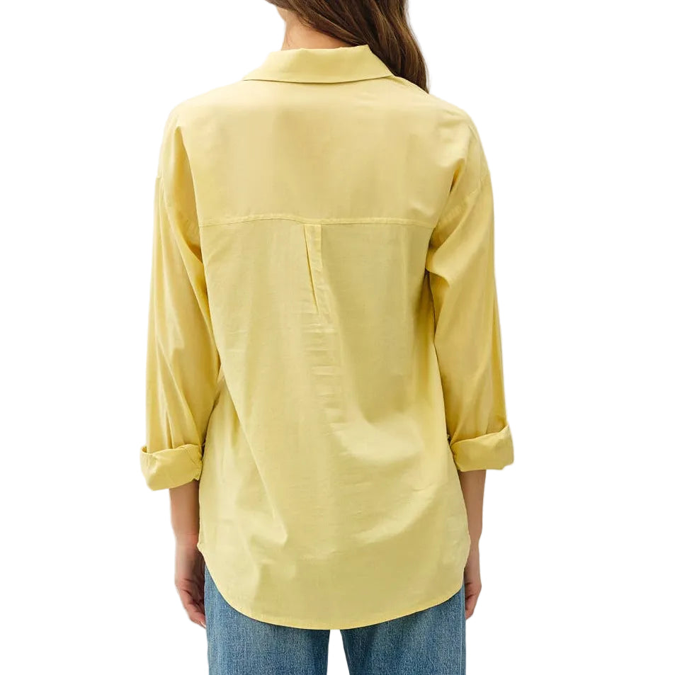 Person wearing a yellow shirt and blue jeans on a white background