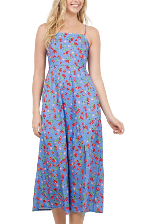 Woman wearing a blue floral dress in a room with plants