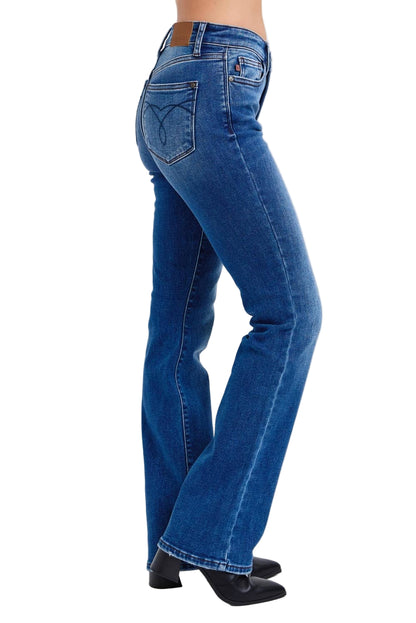 Blue jeans worn by a person on a white background