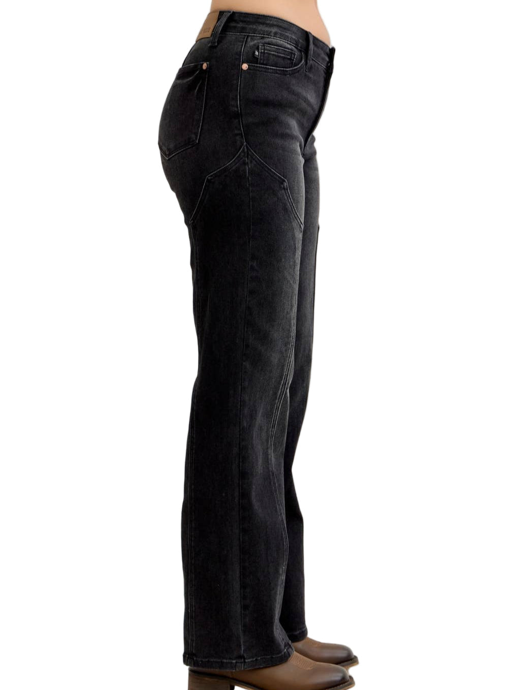 Black jeans worn by a person on a plain background