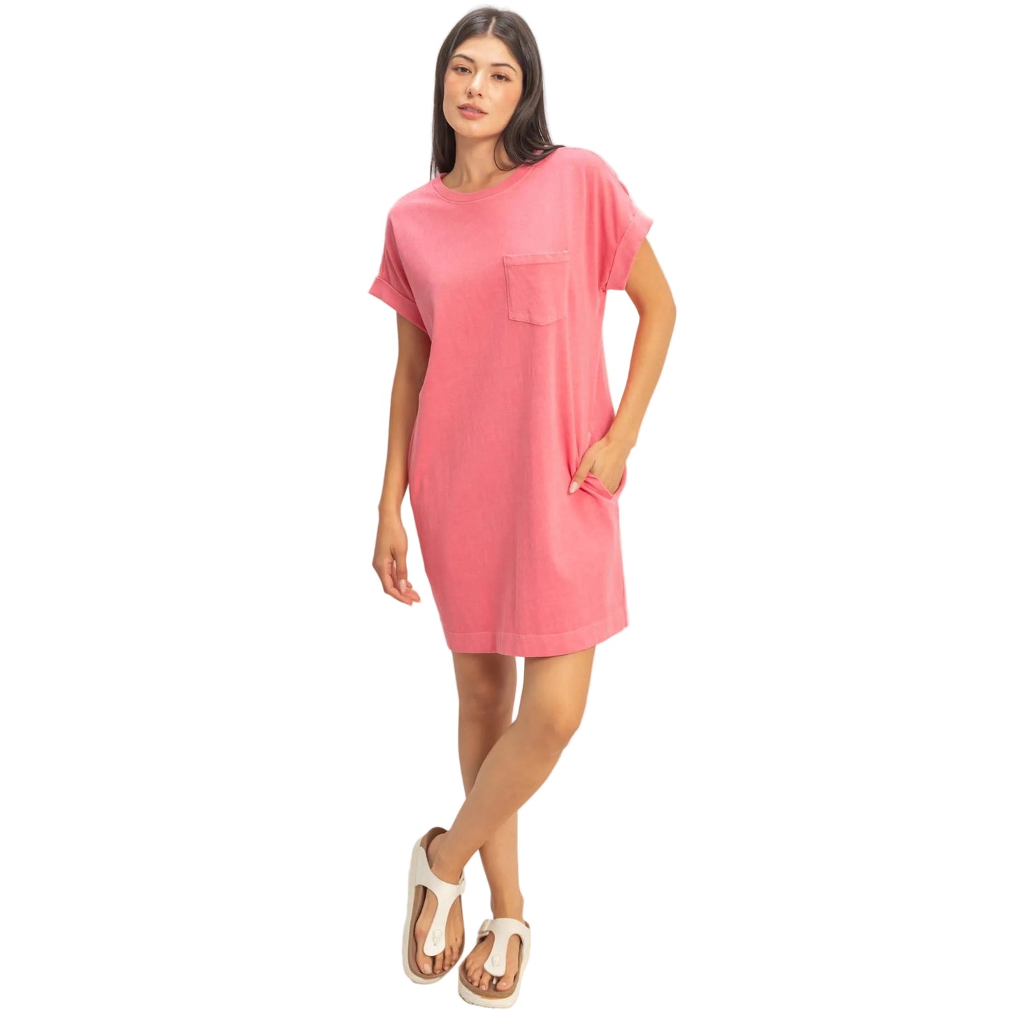 Woman wearing a pink t-shirt dress on a plain background