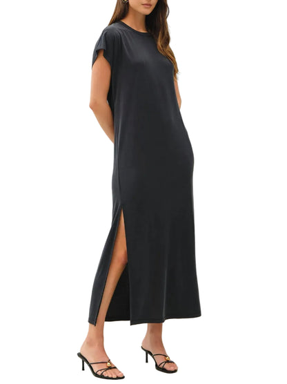 Woman wearing a black dress with a slit on a white background