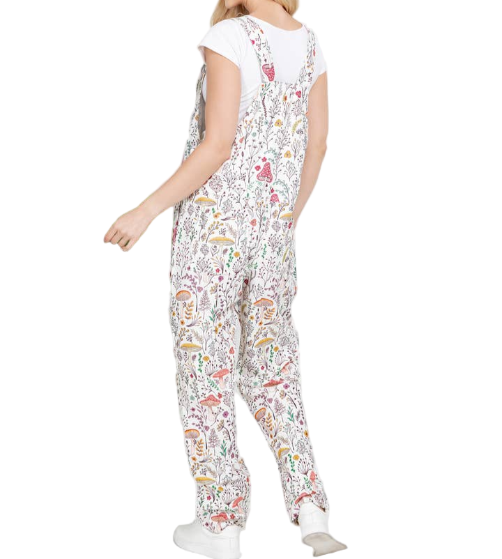Woman wearing a floral patterned jumpsuit on a white background