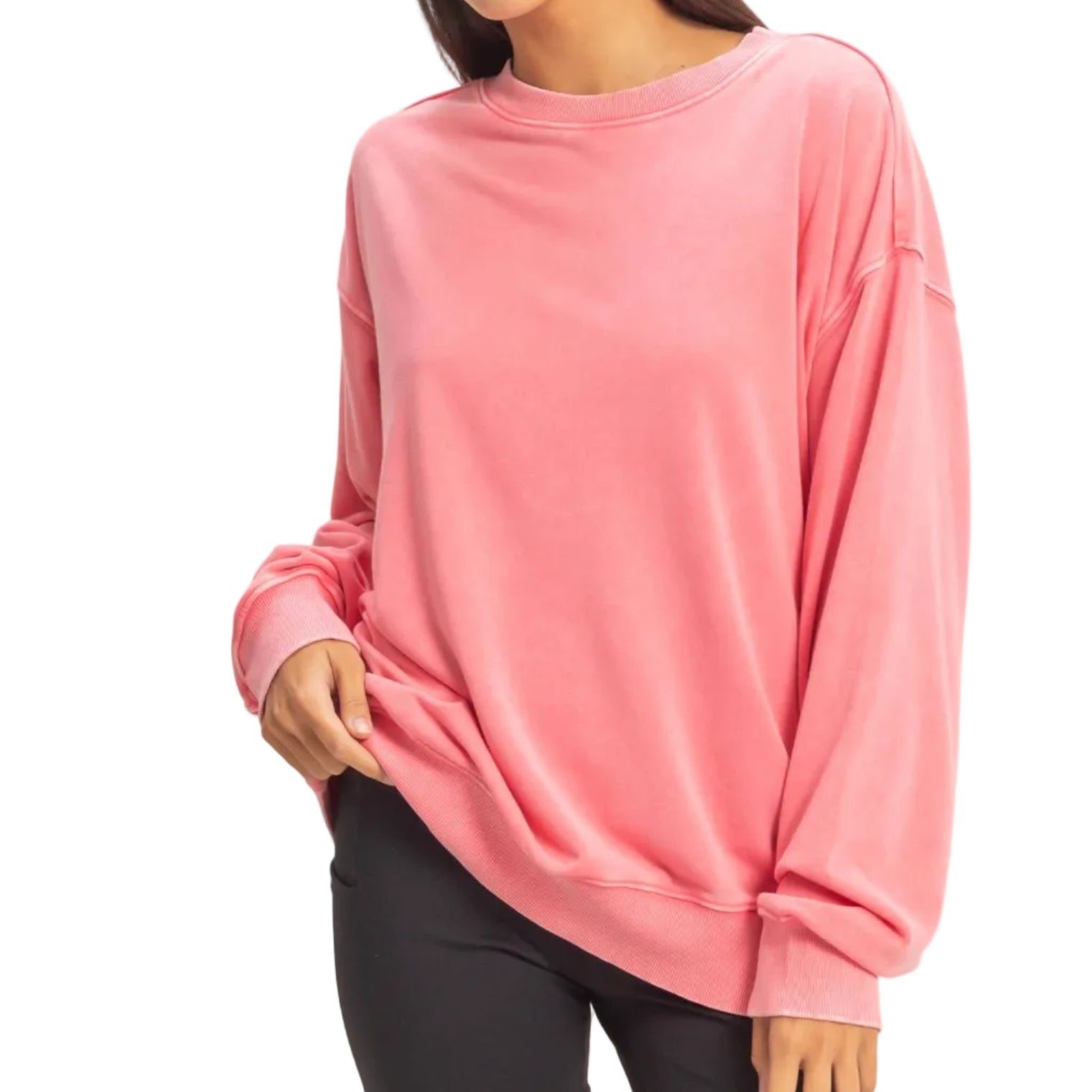 Woman wearing a pink sweatshirt on a beige background