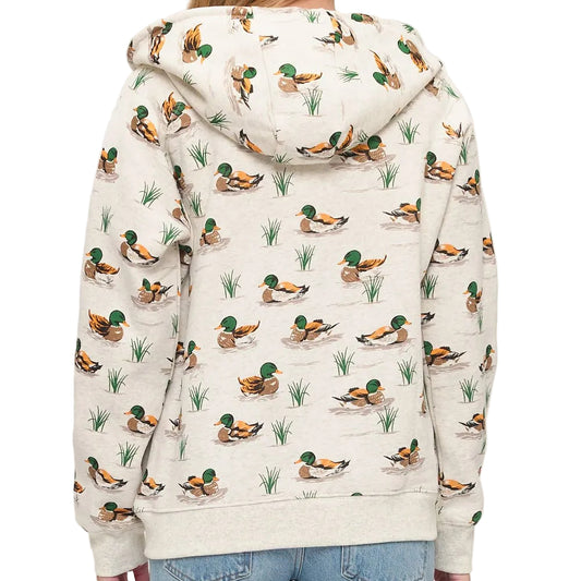 Person wearing a hoodie with duck pattern on a plain background